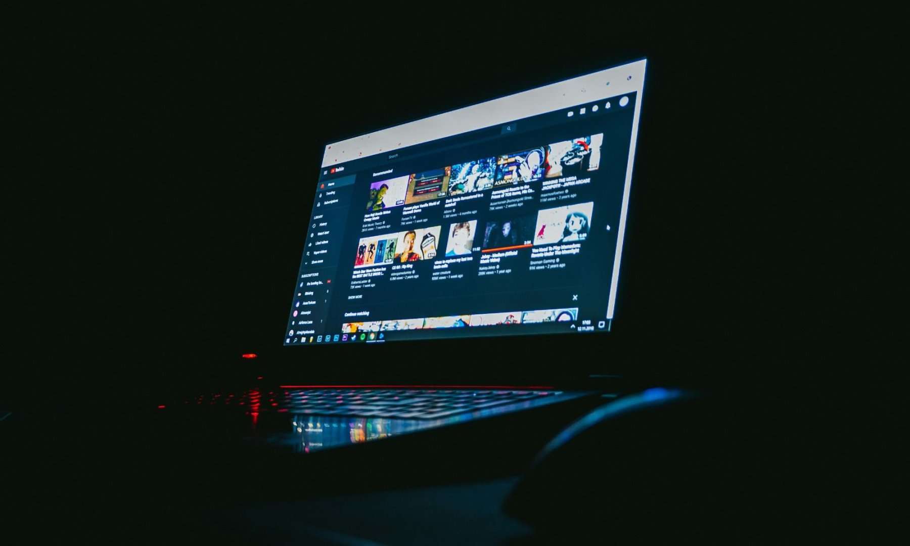 YouTube on a laptop screen in a dark room.