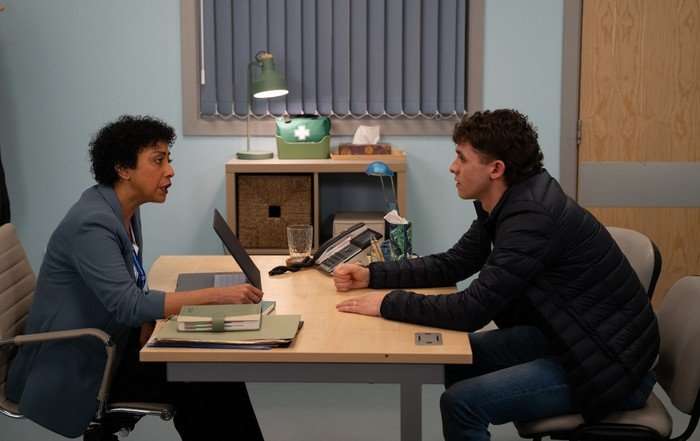 Jacob talks to a HR representative in a scene from Emmerdale