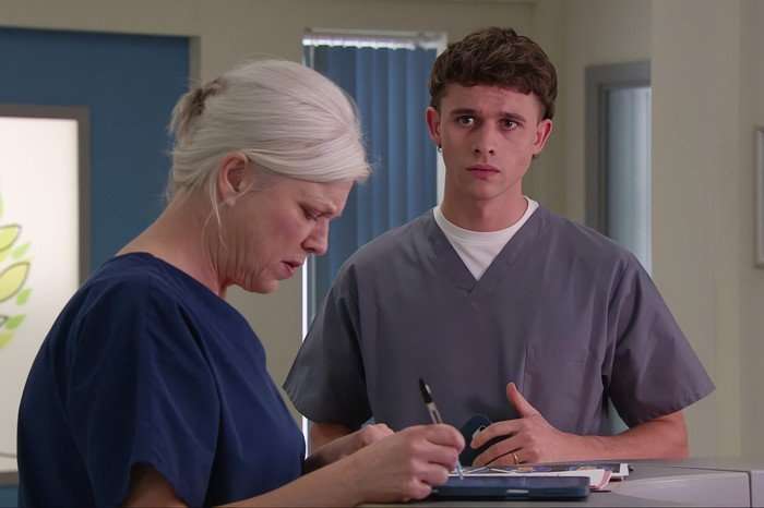 Jacob looks towards Dr Todd in the hospital in a scene from Emmerdale