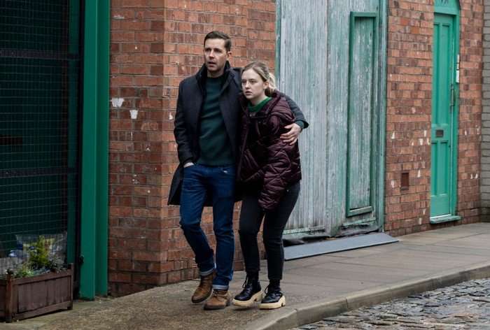 Todd wraps his arm around a distraught Summer outside of the builder's yard in a scene from Coronation Street