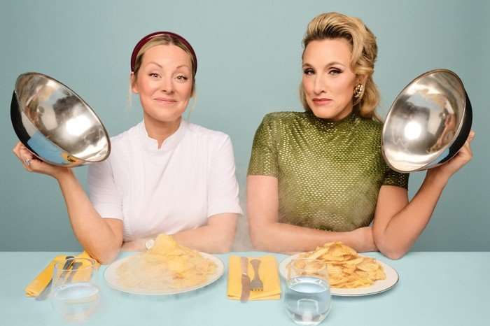 Anna Haugh and Grace Dent sat down next to each other opening a plate of food.