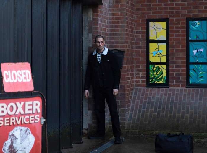 Carl Webster stands alone beside the Websters' Autocentre in Coronation Street