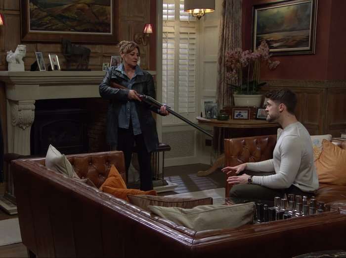 Moira aims a gun at Joe in a scene from Emmerdale