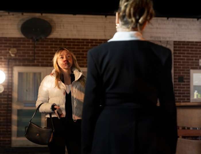 A bloody Megan talks to Megan on the precinct walkway in a scene from Coronation Street