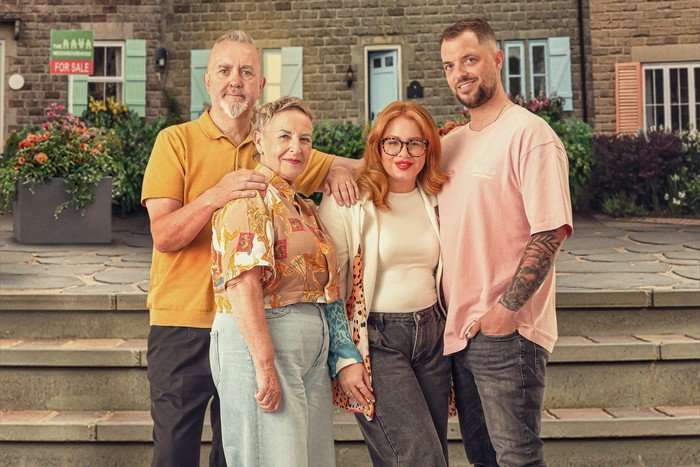 A family of four are standing in front of a row of houses. They are in two couples &ndash; on the left is Dave in a yellow shirt and black trousers, with his arm on the shoulder of his wife Christine, who is wearing a yellow floral shirt and a jean skirt. On the right is Katie, who is a redhead with glasses, a white shirt and black jeans, and Jordan, in a pink shirt and black stonewash jeans