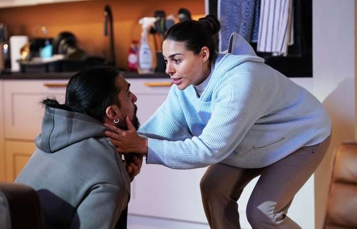 Priya holds Ravi's face in EastEnders