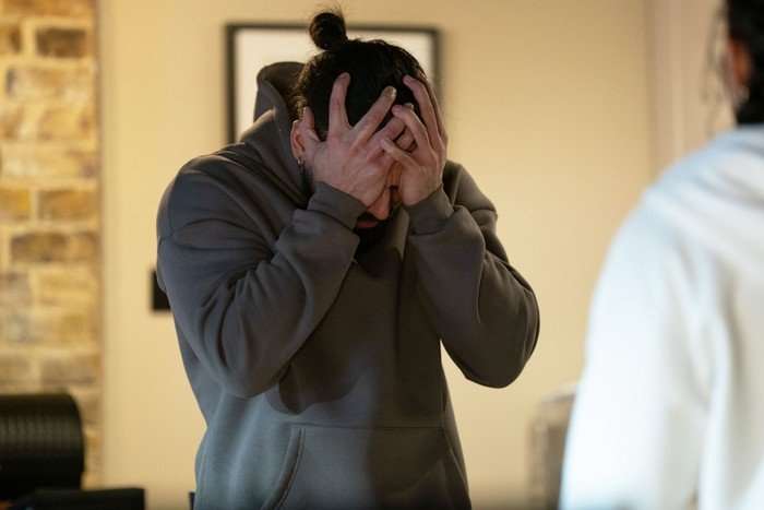 Ravi with his head in his hands in a scene from EastEnders
