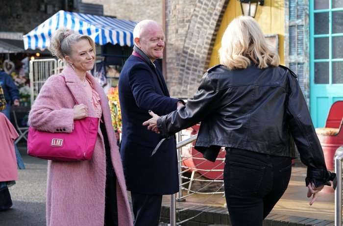 Cindy walks towards Max with her arms outstretched as Linda watches on in a scene from EastEnders