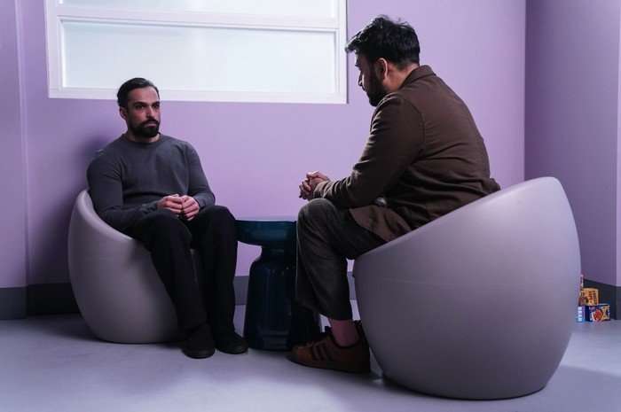 Ravi chats to a mental health practitioner in a secure unit in a scene from EastEnders