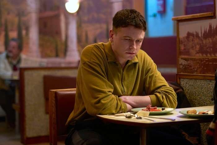 Stuart Campbell as Young Ruben in Half Man, sat at a table in a diner.