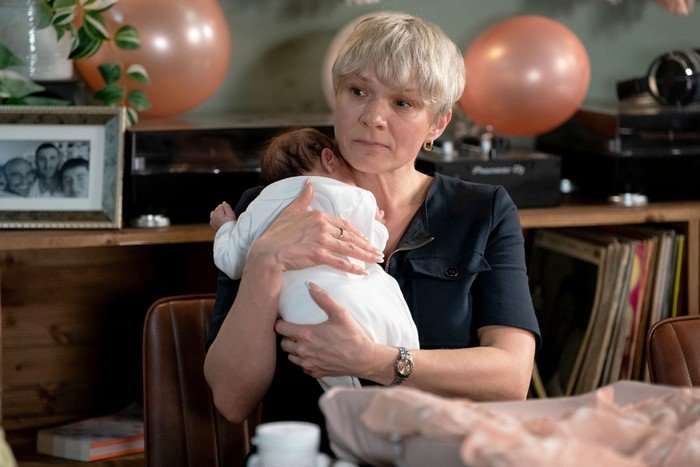 Nicola cradles baby Ivy in a scene from EastEnders