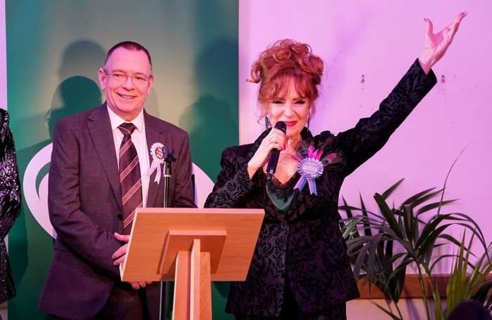 Ian and Elaine stood on a stage in a scene from EastEnders