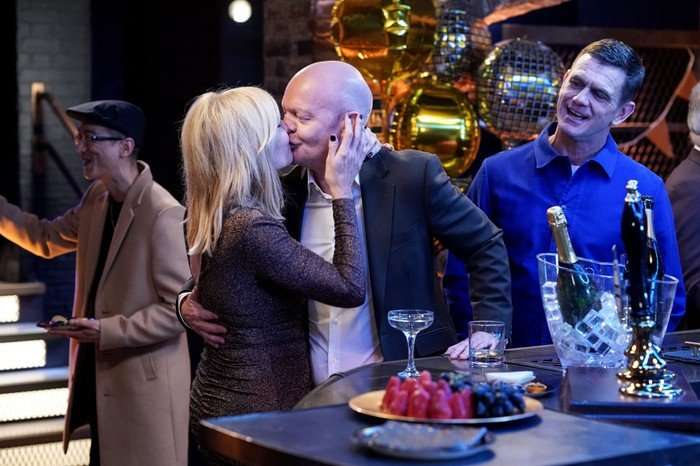 Jack watches as Max kisses Cindy in a scene from EastEnders