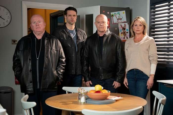 Phil, Mark, Grant and Sam stand in Phil's kitchen in key art for EastEnders