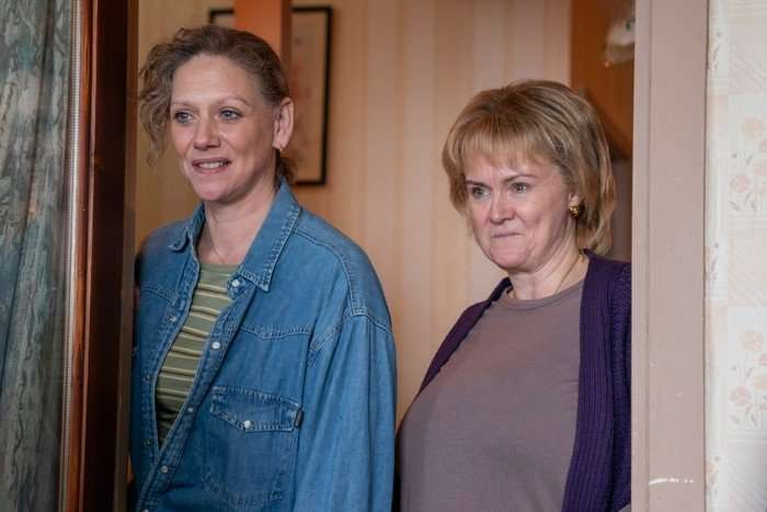 Neve McIntosh as Lori and Marianne McIvor as Maura in Half Man, stood together in a house, smiling.