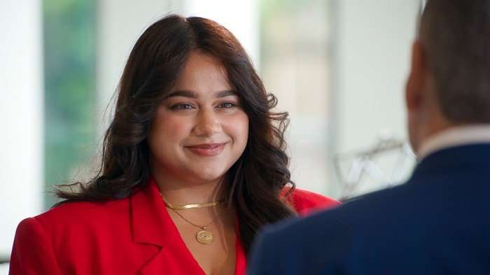 Karishma Vijay sat opposite Mike Soutar smiling ahead.