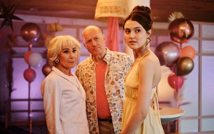 Zo&euml; Wanamaker, Chlo&eacute; Sweetlove and Adrian Edmondson in Bergerac, stood together at a party, with balloons around them.