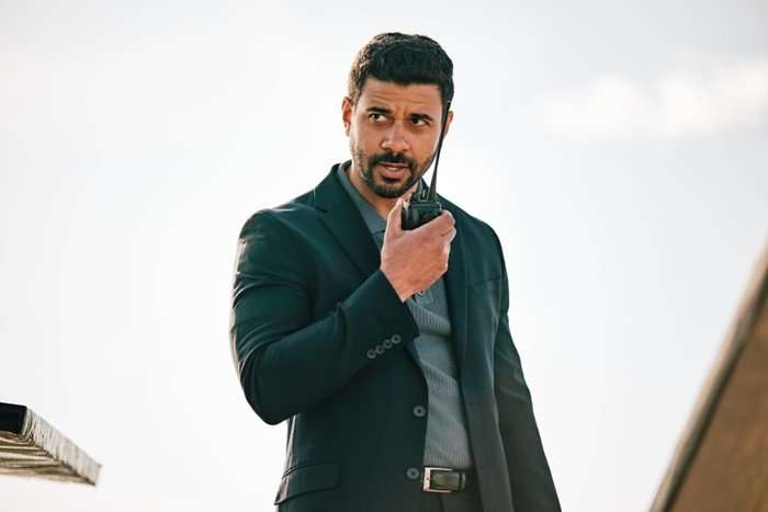 Robert Gilbert in Bergerac, stood outside and speaking into a radio.