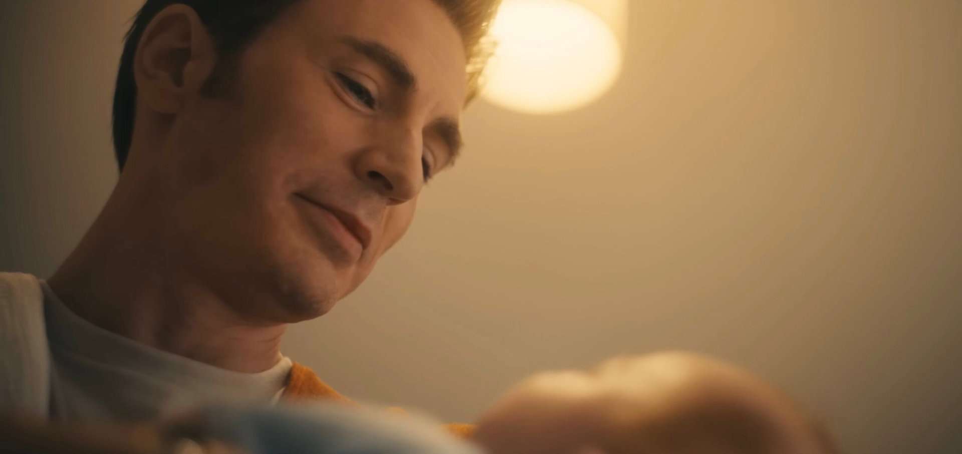 Chris Evans as Steve Rogers holding a baby in Avengers: Doomsday.