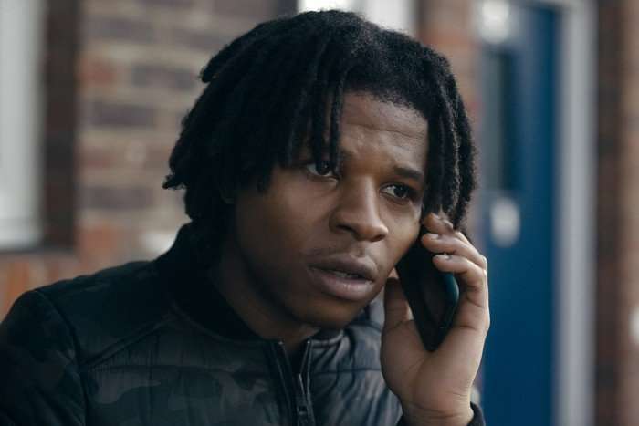 Rasaq Kukoyi in Criminal Record, wearing a black puffer jacket and speaking on the phone.