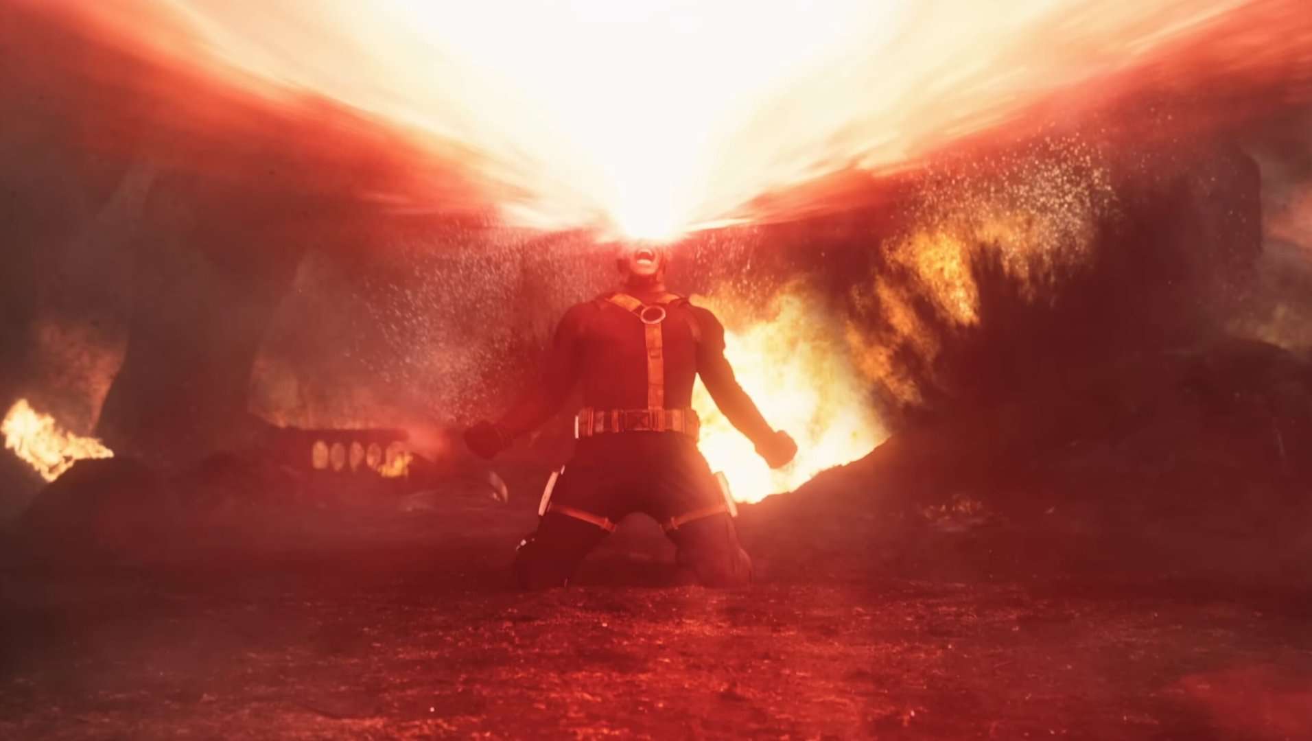 Cyclops (James Marsden) firing a massive laser from his eyes on a fiery battlefield in the Marvel film Avengers Doomsday.