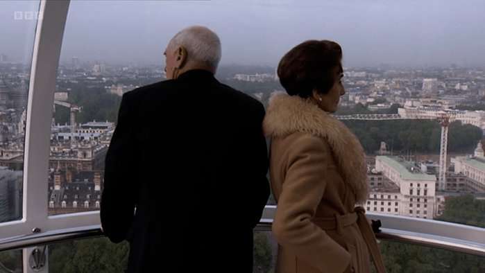 Jim Branning and Dot Cotton stand looking out of the London Eye back-to-back in a scene from EastEnders.