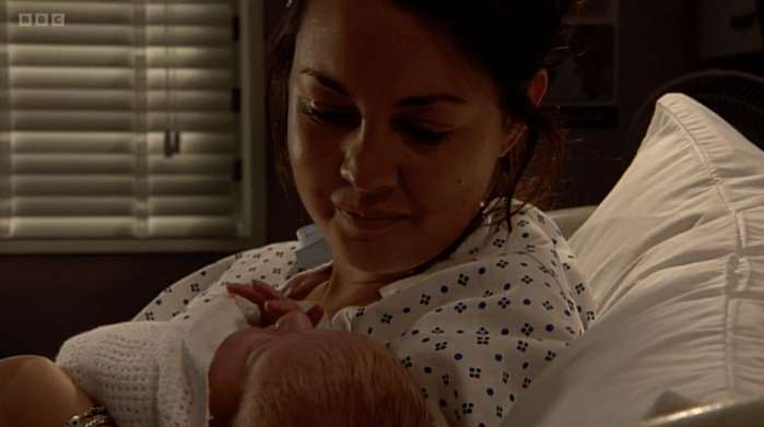 Stacey Branning holds her newborn daughter Lily in her arms in EastEnders in 2010.