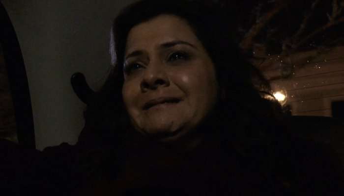 A crying Nina Wadia as Zainab Masood in the back of a taxi at night in EastEnders.