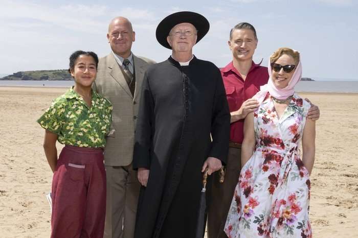 Mark Williams, Tom Chambers, Claudie Blakley, John Burton and Ruby-May Martinwood in Father Brown, stood on the beach together.