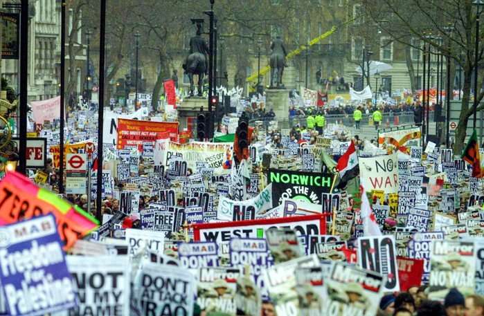Crowds of people in London holding placards for an anti-war demonstration in 20033.
