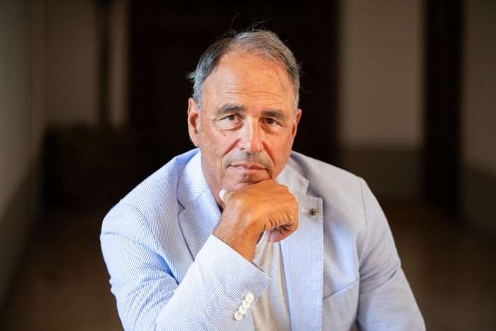 Anthony Horowitz with his hand to his chin, looking at the camera