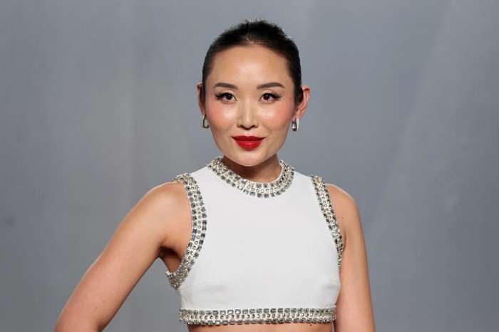 Li Jun Li in a bejewelled white crop top, posing on a red carpet