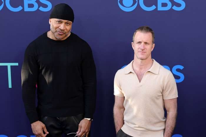 LL Cool J and Scott Caan, stood together in front of a blue backdrop.