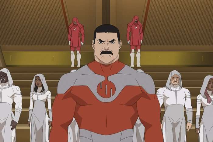 Thragg (voiced by Lee Pace) in a scene from Invincible season 4. He is standing in the centre of the frame, looking ahead determinedly, with hooded figures in the background behind him