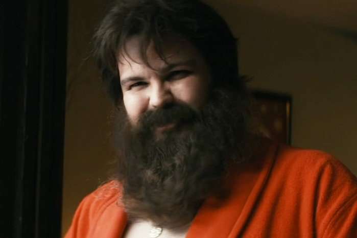 Derek Johns as Love Sausage in The Boys, with a bushy brown beard and wearing a red robe.