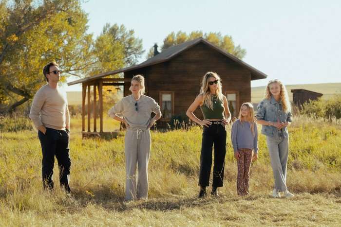 Patrick J. Adams as Russell McIntosh, Elle Chapman as Paige McIntosh, Beau Garrett as Abigail Reese, Alaina Pollack as Macy Reese and Amiah Miller as Brigitte Reese in The Madison, stood in front of a cabin.
