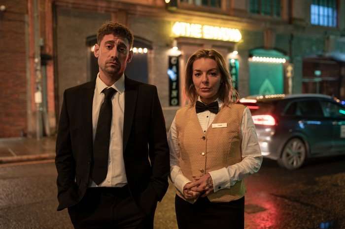 Michael Socha and Sheridan Smith stood next to each other looking mischevious.