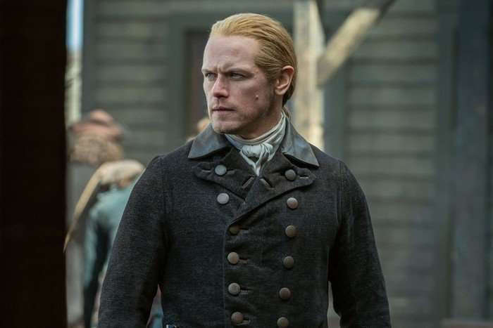 Sam Heughan in Outlander wearing a dark coat