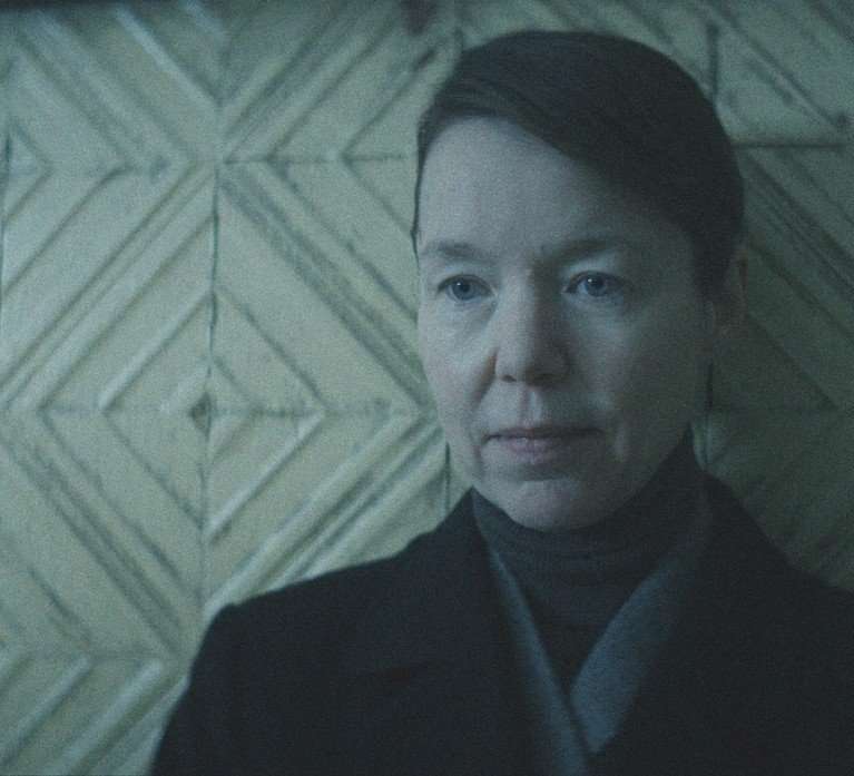 Anna Maxwell Martin in Star City, wearing dark clothes and standing against a stark, geometric backdrop.
