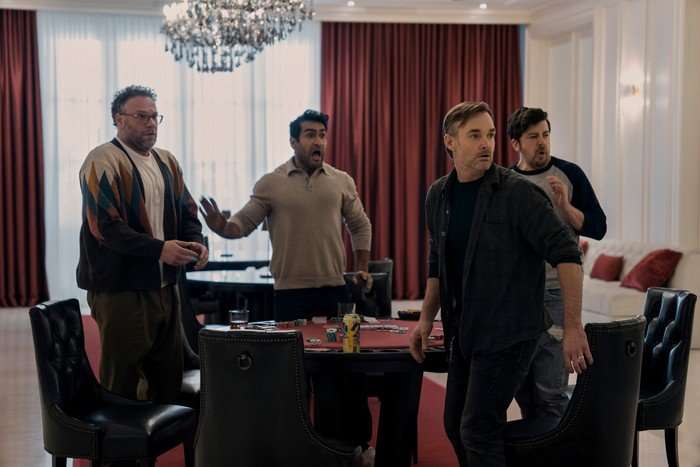 Seth Rogen, Kumail Nanjiani, Will Forte and Christopher Mintz-Plasse in The Boys, stood around a table and looking shocked at something off screen.
