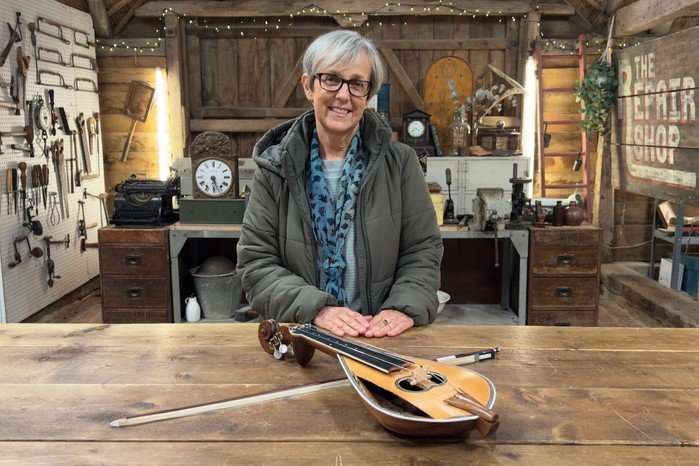 Emma MacLennan standing by a lyra.