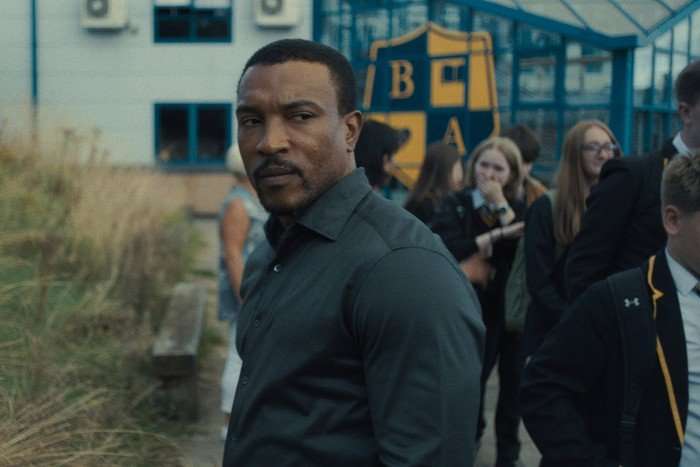 Ashley Walters stars in Adolescence in a black shirt