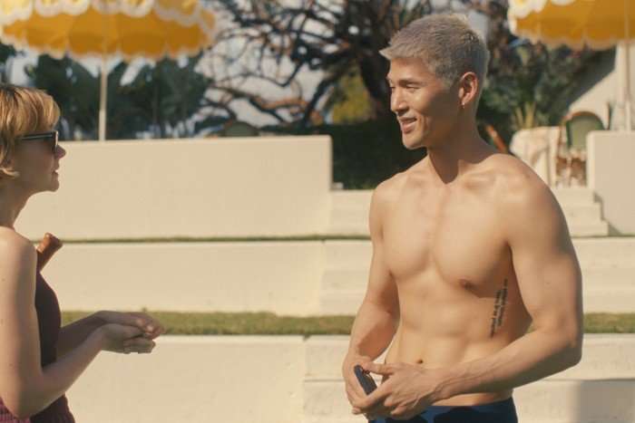 BM (aka Matthew Kim) plays Woosh in Beef season 2; he is outside on a sunny day with his shirt off, smiling at Lindsay as they have a chat