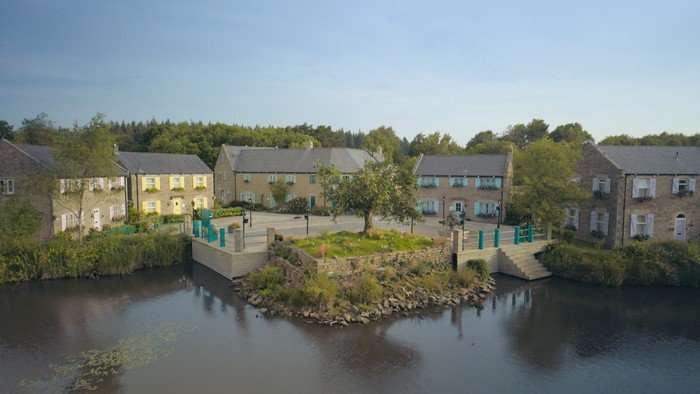 A row of houses pictured by a lake