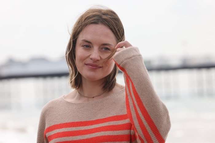 Zo&euml; Tapper as Cleo Morey in Grace wearing a brown and pink jumper