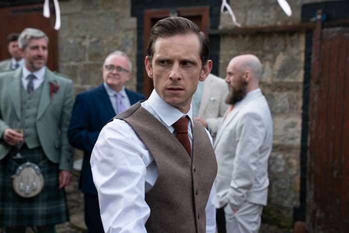 Jamie Bell as Niall in Half Man in a waistcoat and shirt and looking to his side anxiously.