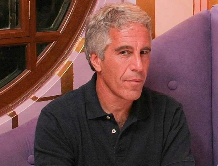 Jeffrey Epstein looking ahead in a photo, wearing a black polo shirt.