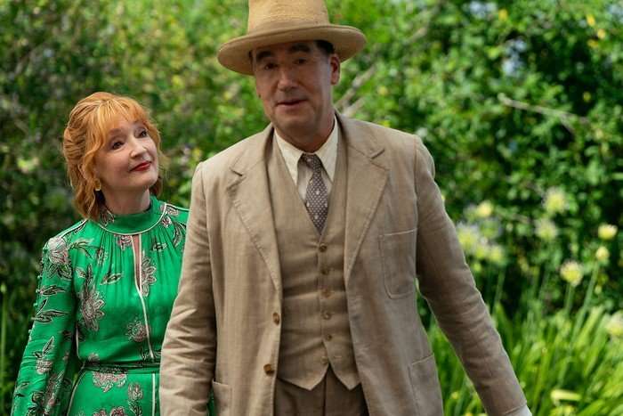 Lesley Manville as Susan Ryeland and Tim McMullan as. Atticus P&uuml;nd in Marble Hall Murders, walking with greenery in the background.