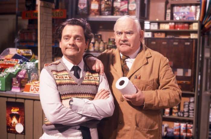 David Jason as Granville and Ronnie Barker as Albert Arkwright, standing in a shop next to each other. Granville has his arms crossed and Arkwright is holding toilet roll and looking confused.