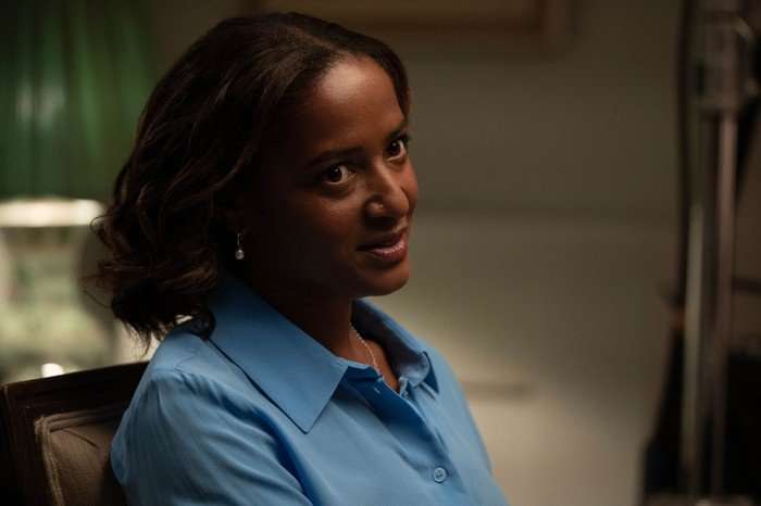 Amaka Okafor as Imogen in Secret Service, wearing a blue shirt.